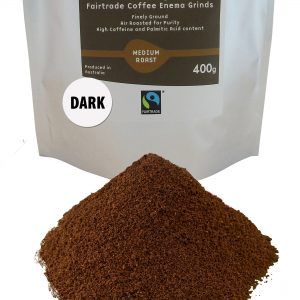a pile of dark roast coffee enema grinds sits in front of its packet